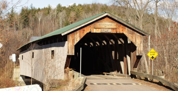 The front of a covered bridge during stick season.