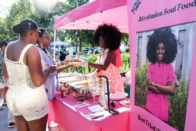 A restaurant owner serves customers at an outdoor festival in Vermont.