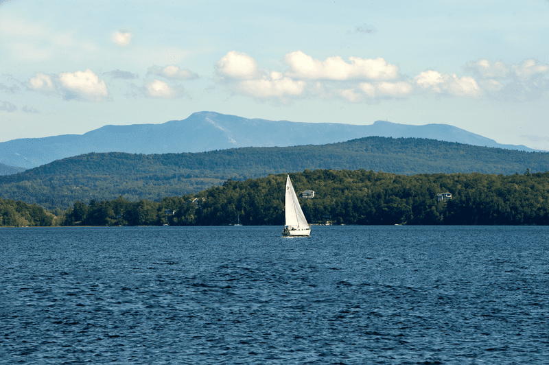 A sailboat on a blue lake.