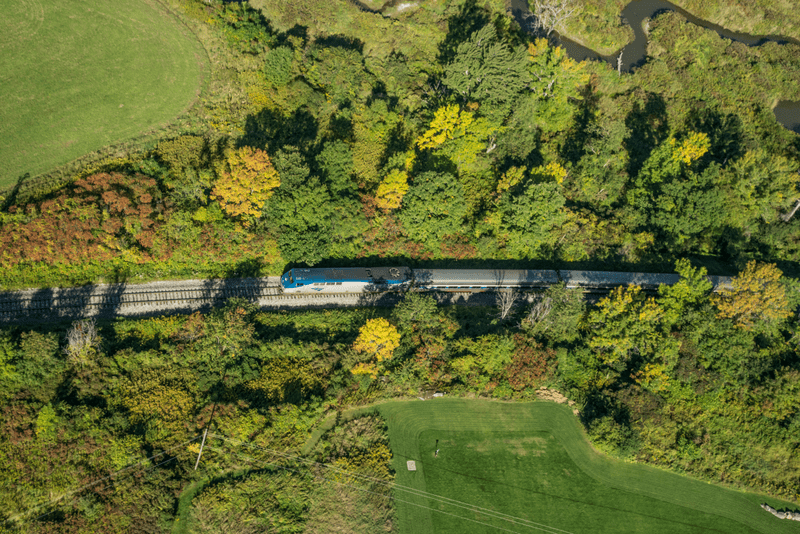 Seen from above, a train moves through Vermont in the summer.
