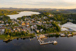 As seen from above, a small town bordering a large body of water.