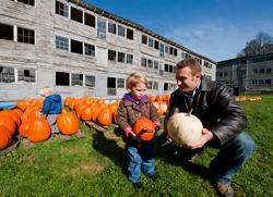 Father and son picking pumpkins.