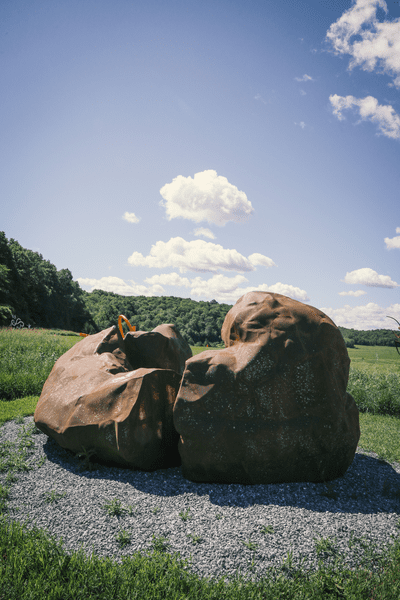 An outdoor sculpture of two boulder-like structures.