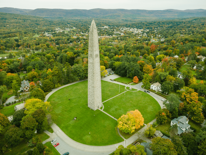 Seen from above, a tall stone monument surrounded by forests.