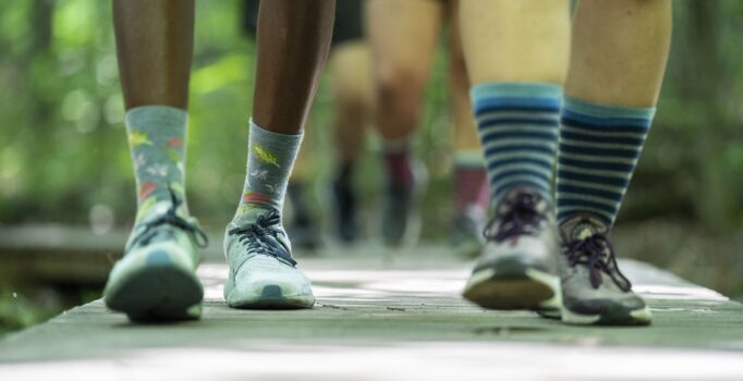 A detail shot of people walking on a boardwalk.