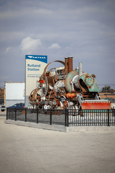 An enclosed train sculpture complements the Amtrak sign for Rutland Station.