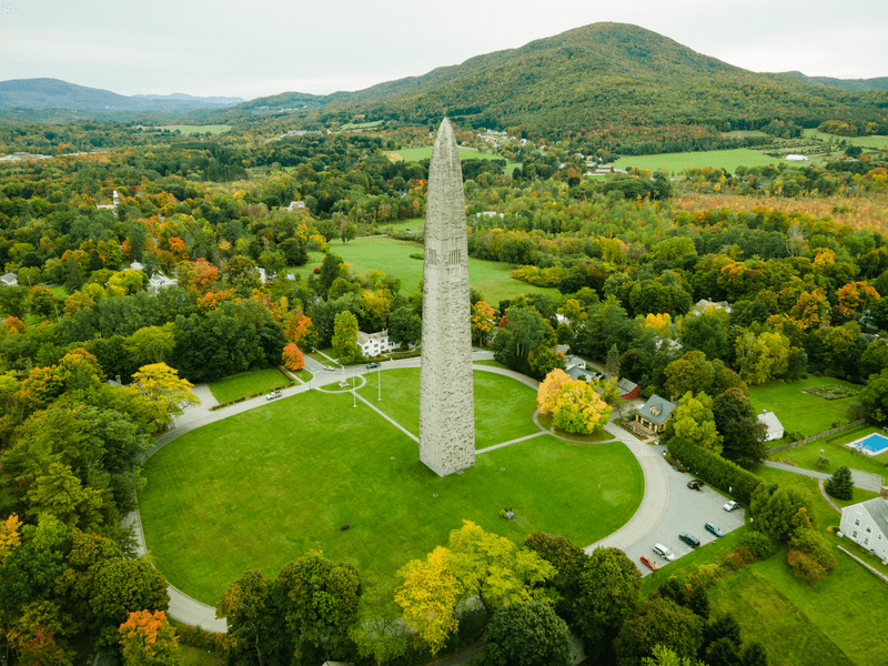 Ariel view of a tall, slender tower with a pointed top in the summer.