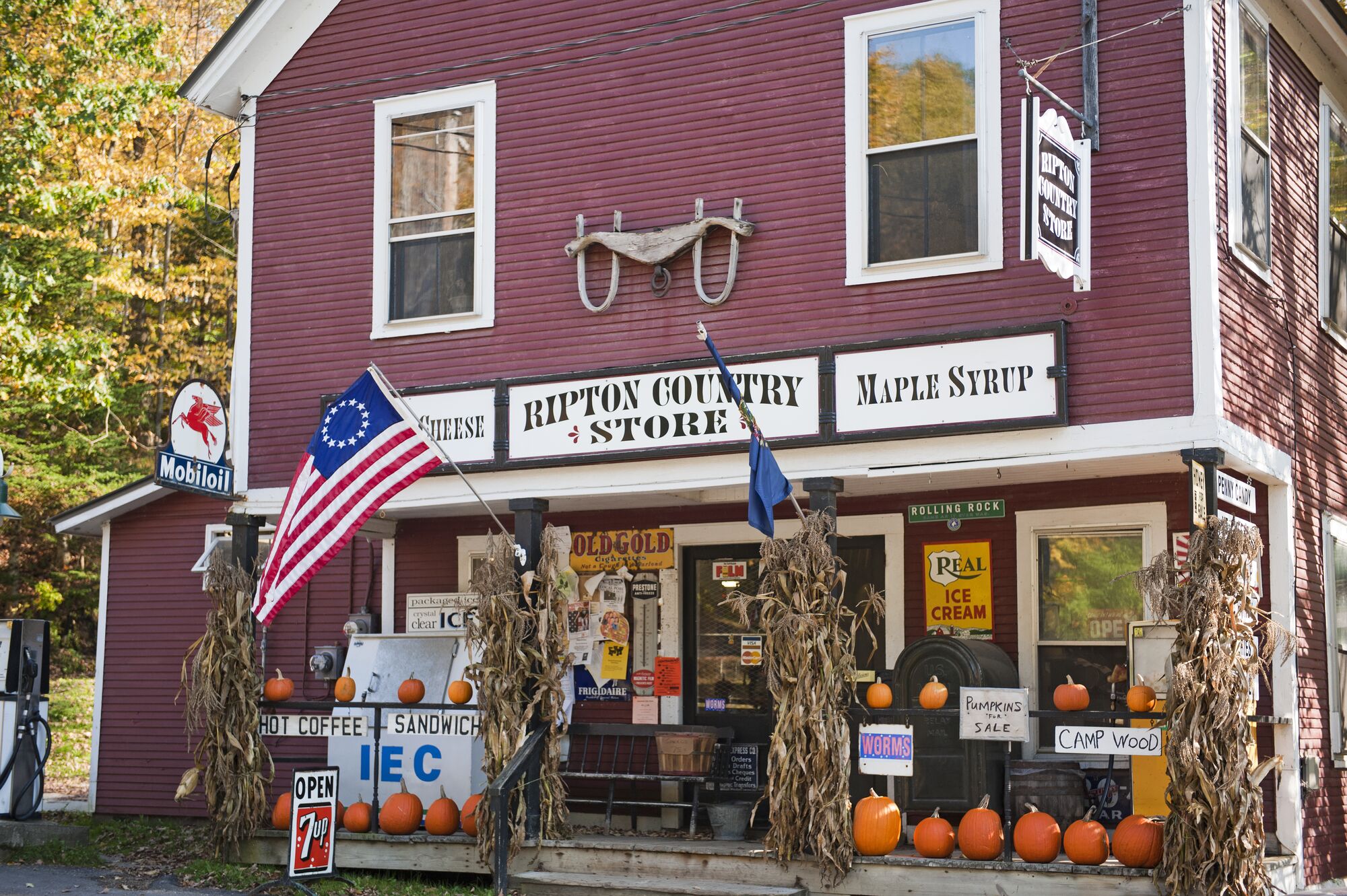 A country store with pumpkins on the front porch in Vermont.