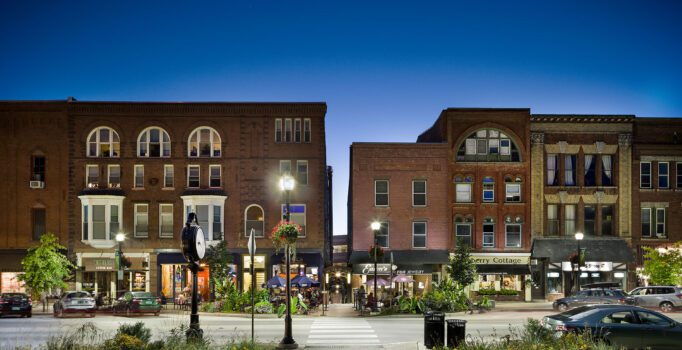 Street view of a historic downtown at dusk.