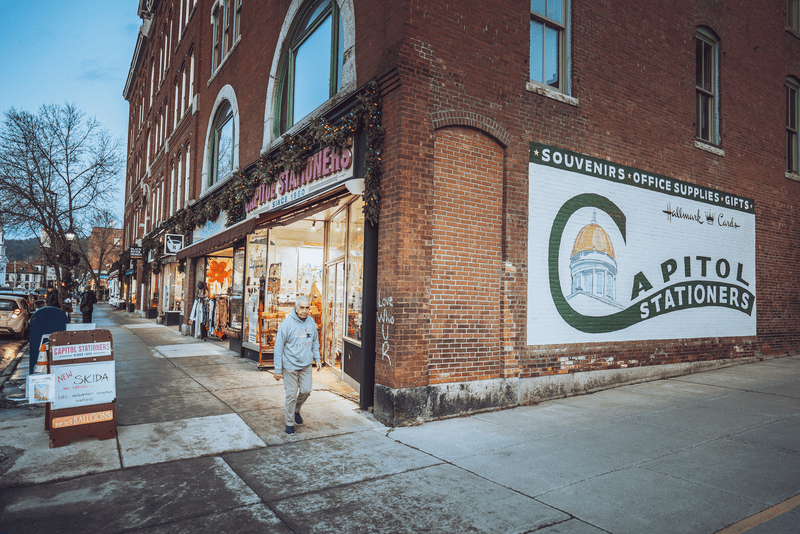 A pedestrian looks at the camera near Capitol Stationers.