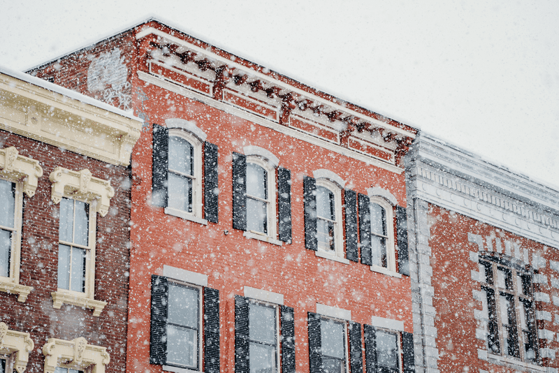 Snowfall obscures the view of brick buildings in Montpelier, Vermont.