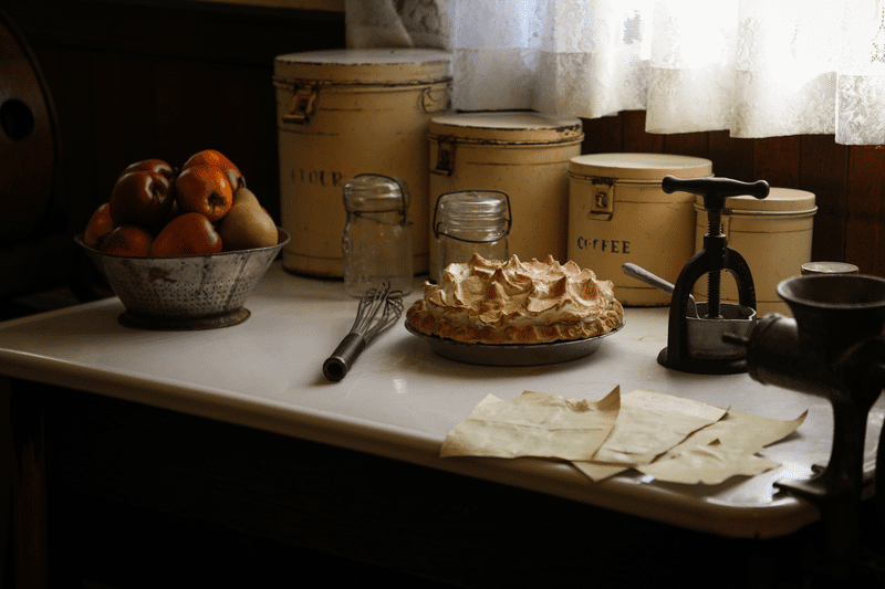 A table setting with pie, fruit, and other objects, at Hildene.