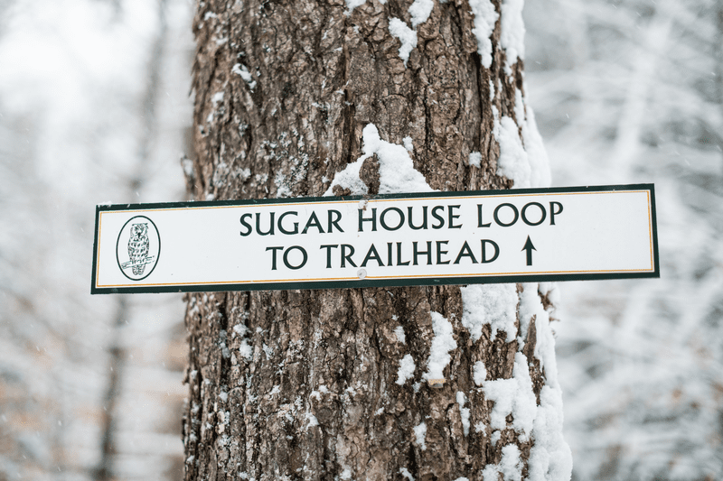 A winter scene closeup of signage reading, 