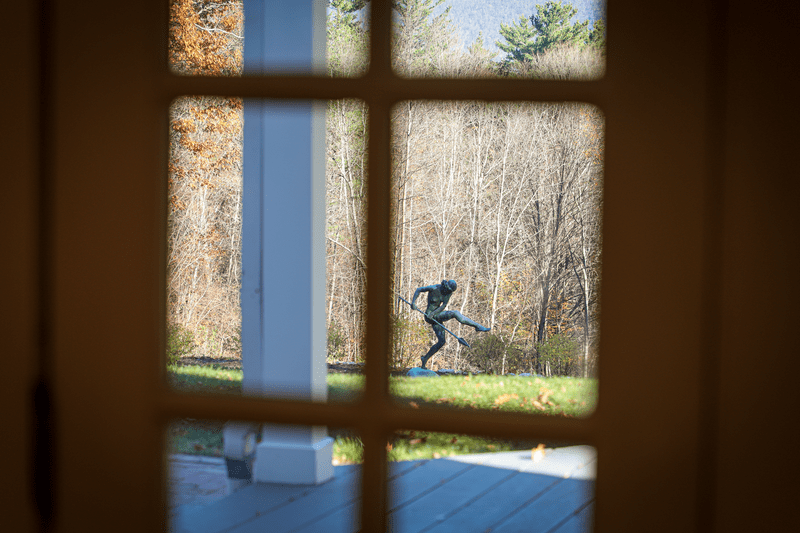 A sculpture outside a glass pane window.