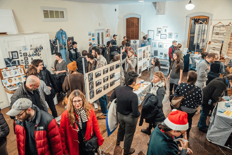 People wearing jackets inside the Art studio, Wishbone Collective, in Winooski, Vermont.