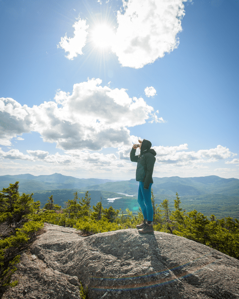 A person drinking Bitter Bubble at the White Rock summit overlook.