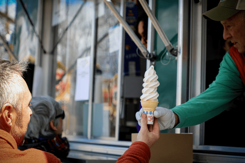 A patron receives a Maple Creemee from a food truck at the Vermont Maple Festival.