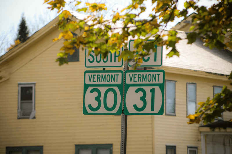 An early autumn image of road signage for Vermont route 30 South, and the junction of Vermont route 31.