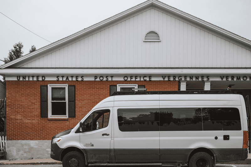 A camper van sits parked in front of the United States Post Office, Vergennes, Vermont.