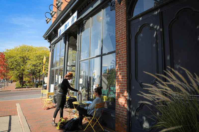 A coffee shop storefront with outside seating.