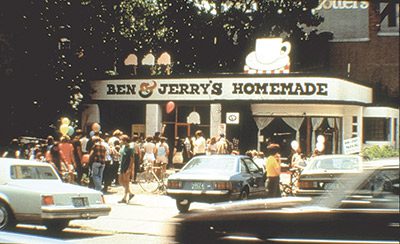 A group of people wait in line at an ice cream stand named Ben & Jerry's Homemade in the 1970s.
