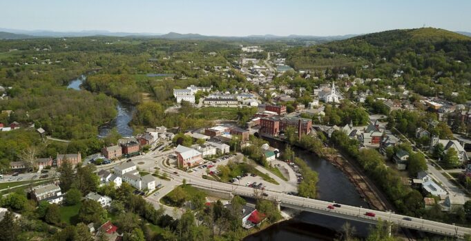 Seen from above, a rural mountain town surrounded by trees.