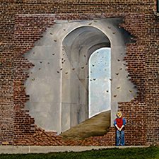 A brick wall with a painted mural. The mural is painted to look like the bricks are peeling away to unearth a tunnel.