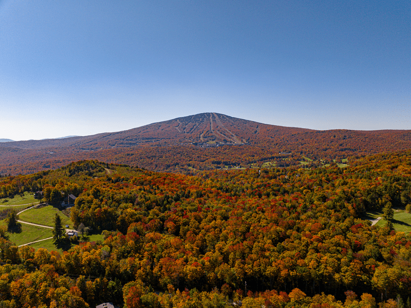 A view of Stratton Mountain from afar in the fall on a sunny day.