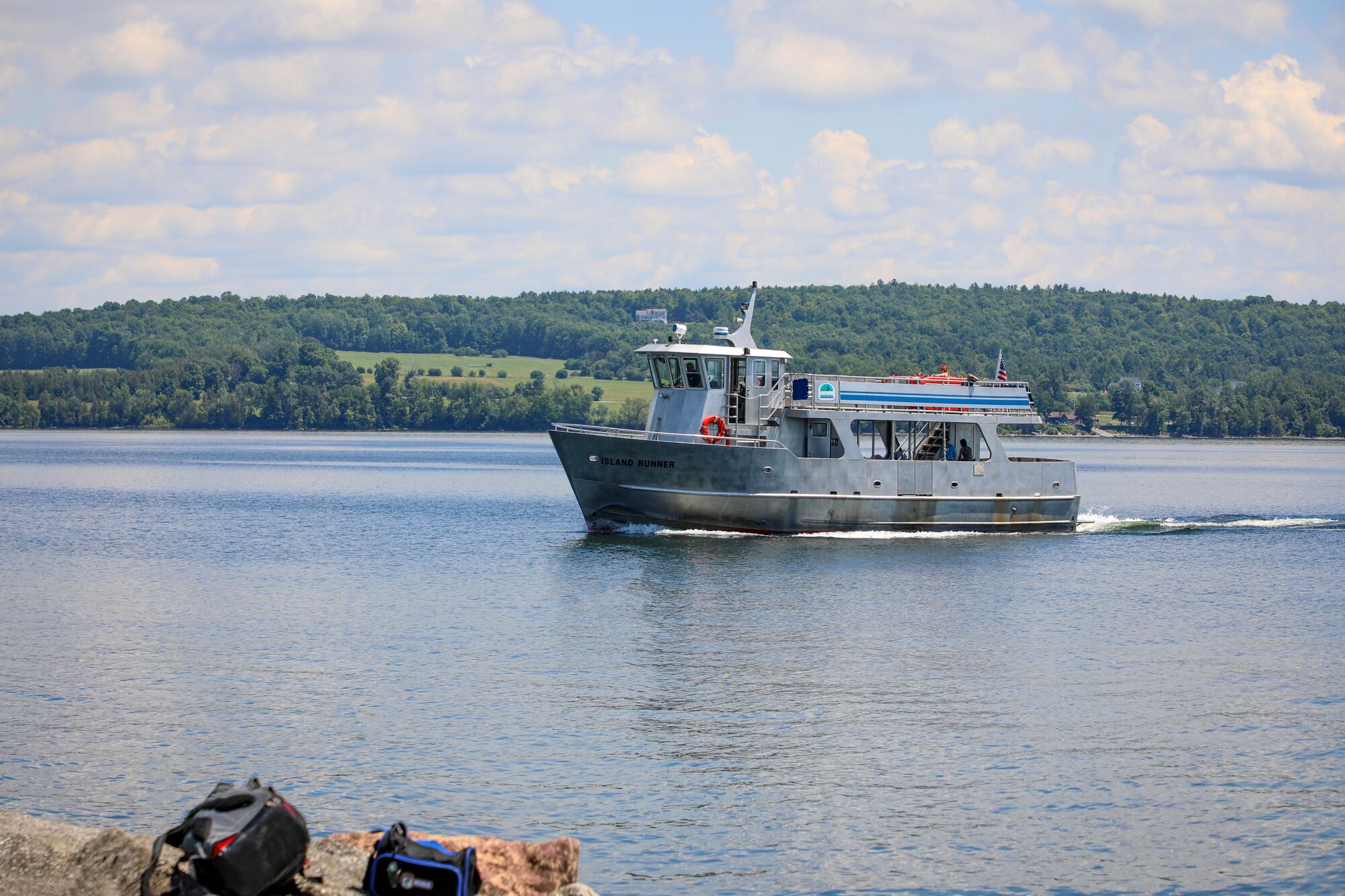 A small ferry boat on a lake on a sunny summer day.