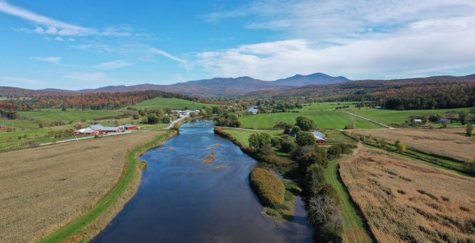 Seen from above, a gravel path along a river.