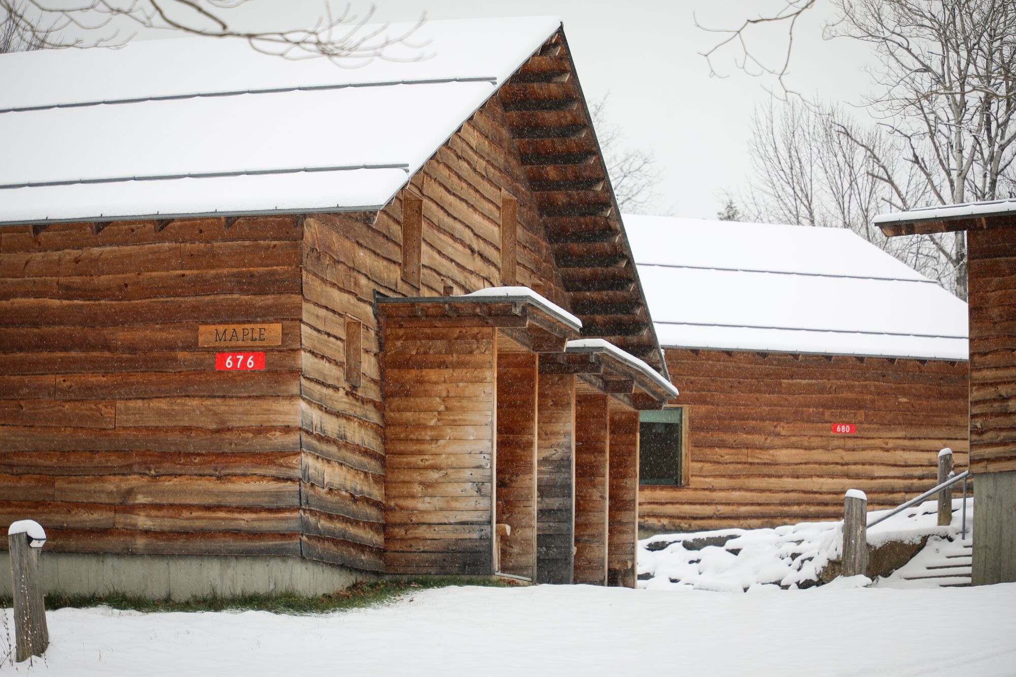 Wooden cabins in the snow on a winter day seen from outside. 