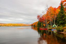 Camping along riverside during peak fall foliage.