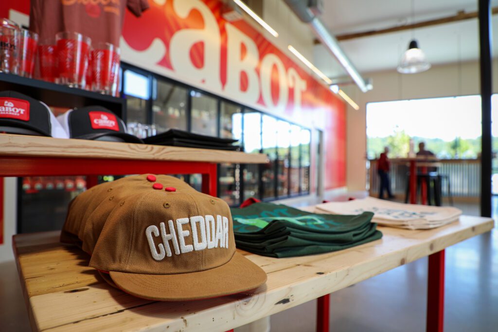 Canvas hat reads Cheddar at the Hardwick Visitors’ Center Cabot Store.