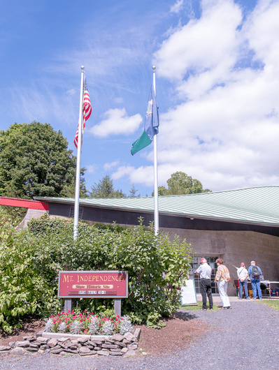 People tour the exterior of a museum.