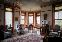 Seen from across a room, a spacious living space in an old castle.