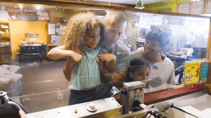 a group of people looking through a glass window