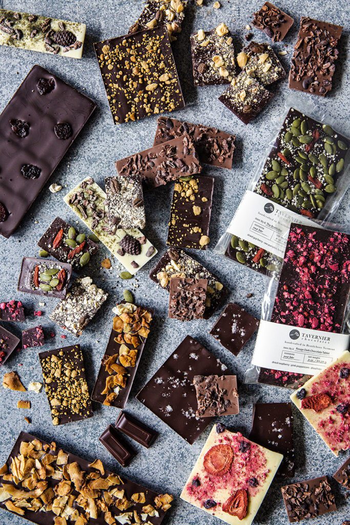 Seen from above, an array of chocolates are displayed on a counter.