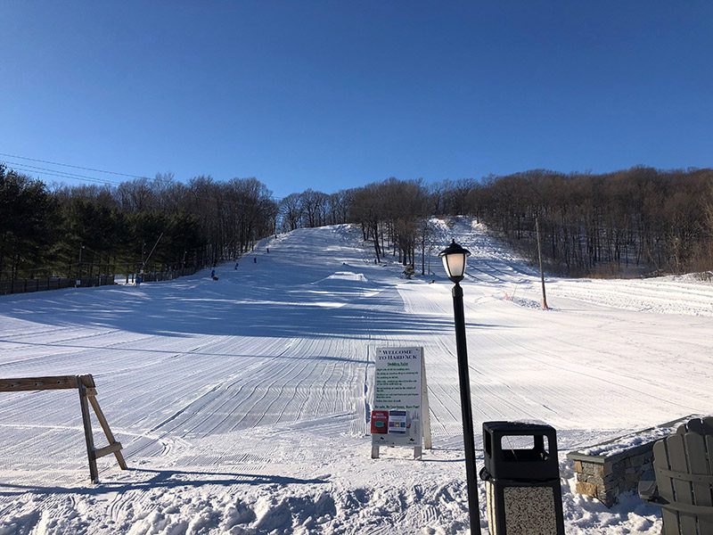 A small, groomed ski slope, as seen from the base.