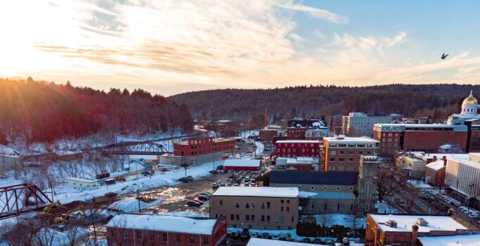 Seen from above, a snow-covered mountain town at sunrise.