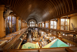 A large room with science exhibits across two floors.