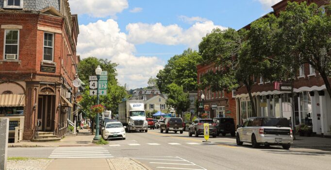 A bustling rural downtown with brick buildings and storefronts.