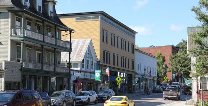Seen from afar, old buildings with store fronts in a rural downtown.
