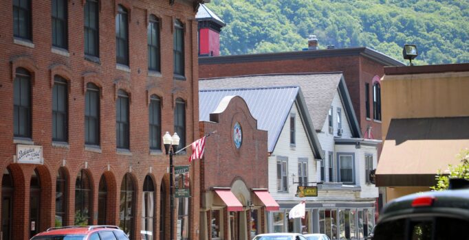 Brick buildings line a small rural downtown street.