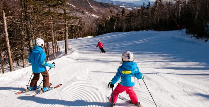 A family group skiing down Vermont's slopes.