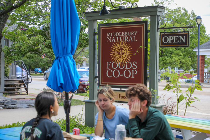 People eating outside at a restaurant in the summer.