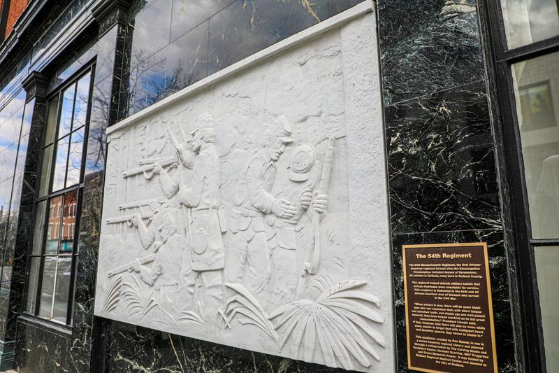 A stone sculpture on a wall.