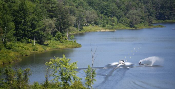 Seen from above, a person waterskiing in a body of water.