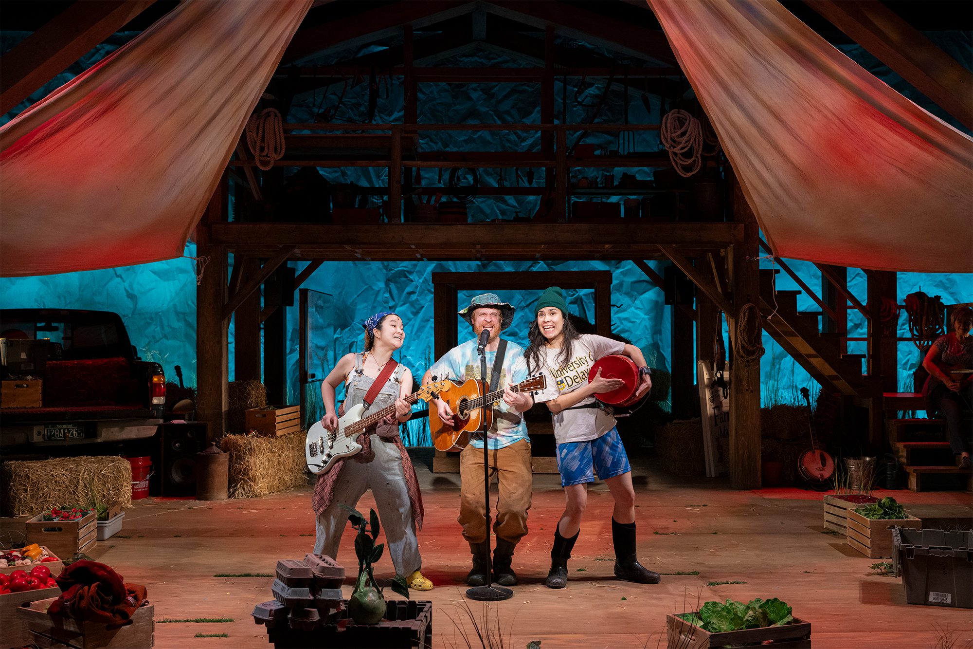 People in costumes on a stage putting on a performance. 