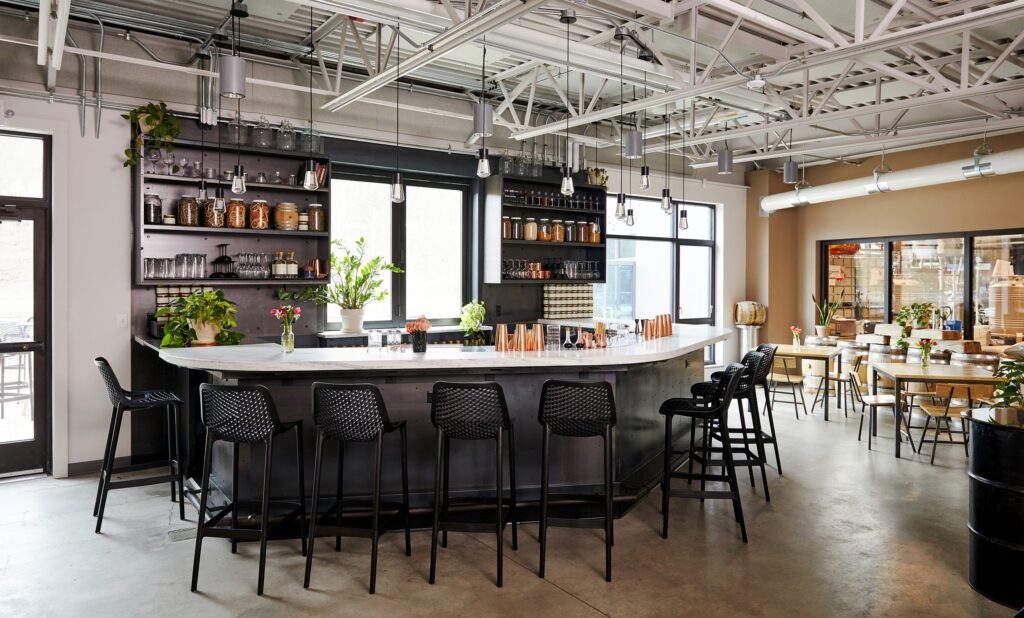 A modern bar with an industrial feel seen in the interior.
