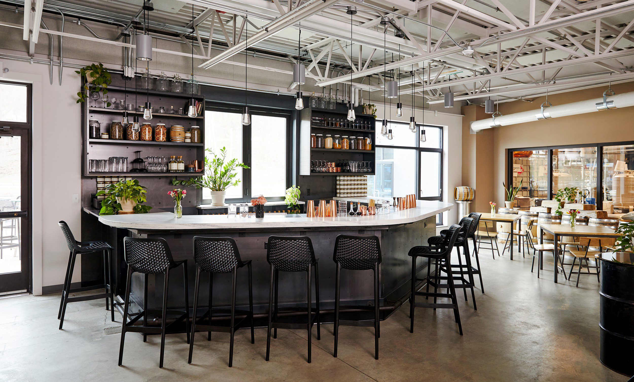 A modern bar with an industrial feel seen in the interior.